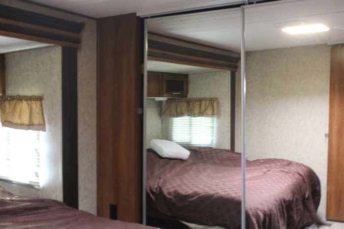 Forest River Large bedroom has sliding mirrored doors over large closet